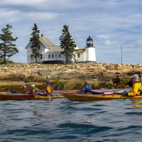 Sea kayaking past Mark Island Light in Winter Harbor