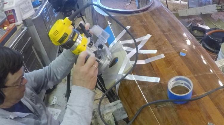 Using a router with the template to add a wood deck fitting