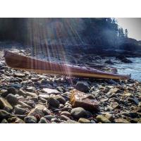 wooden sea kayak on rugged shore